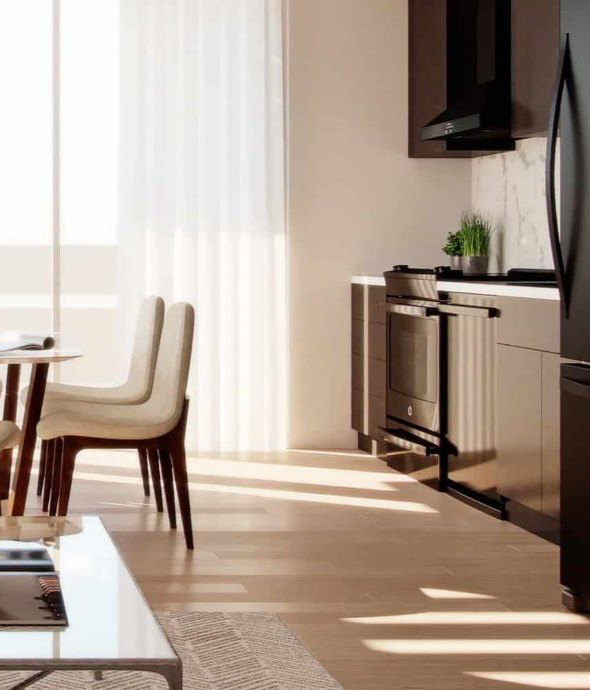 Apartment dining and kitchen area with dining table and modern kitchen.